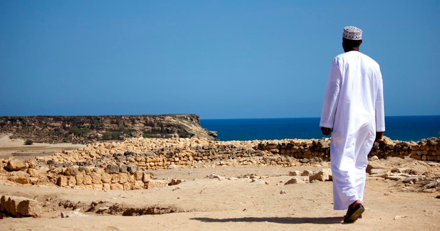 Arabic attire at a coastal heritage site